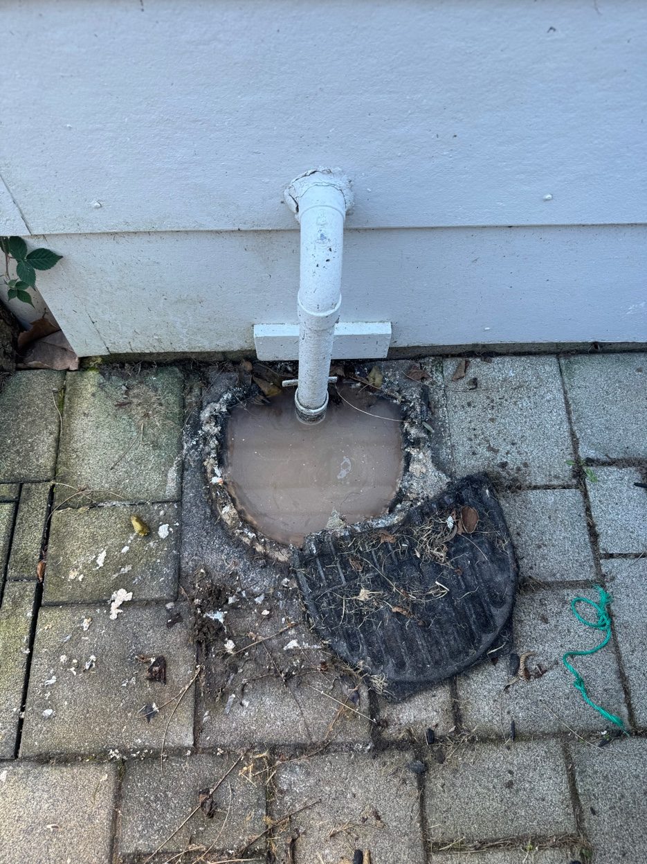 Blocked gully trap overflowing